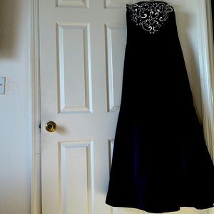 Long black dress with top accented with baroque embroidery.